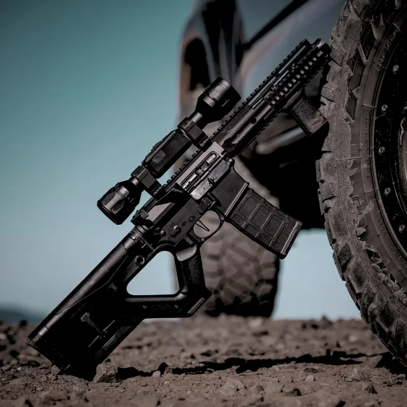 CQR GEN 1.0 (CA) Buttstock BLACK 8 Close-up of Hera Arms CQR Gen 1.0 fixed AR-15 stock leaned against a truck for rugged field use